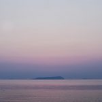 The sun disappeared behind Ibuki island at calm Seto Inland Sea.